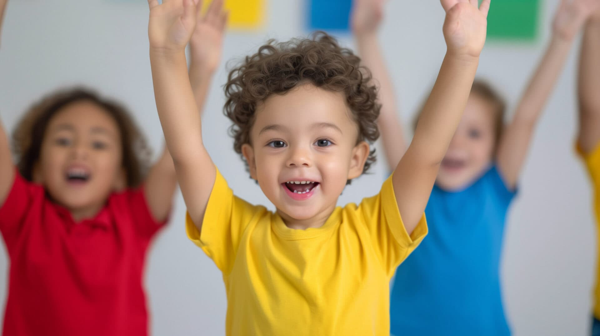 A grinning child stretching both arms overhead during a movement activity with classmates